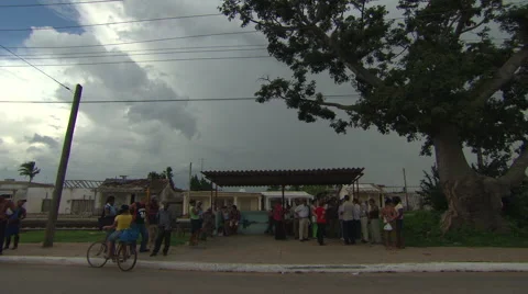 Storm clouds gather over Cuba, people wait for a bus Stock Footage 39995140