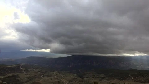 Storm clouds gather over wide forested valley - Tree Structure and Forest Cover Stock Footage 339339748