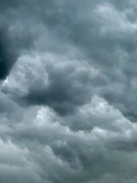 Storm clouds gather before rain falls around midday Stock Photos