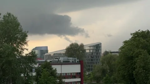 Storm clouds gathering over modern buildings during a gloomy evening in Vilnius Stock Footage 310796891