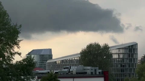 Storm clouds gathering over modern buildings during a gloomy evening in Vilnius Stock Footage 310796907