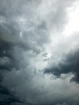Storm clouds gathering overhead, with bright light piercing through gaps Stock Photos