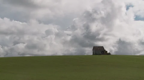 Storm clouds, green field abandoned hut time lapse Stock-Footage 38955407