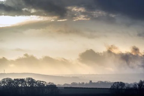 Storm clouds hovering over St Paternus church North Petherwin Foto stock