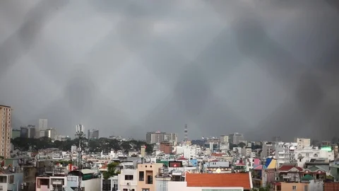 Storm clouds with lightning strike bolts passing over night city of Ho Chi Minh Stock Footage 75741113