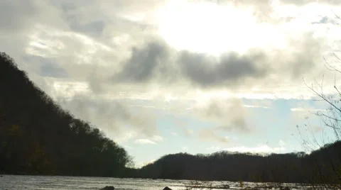 Storm Clouds Mountain River with Blue Skies and Sun Time Lapse, 4K Stock Footage 57254914