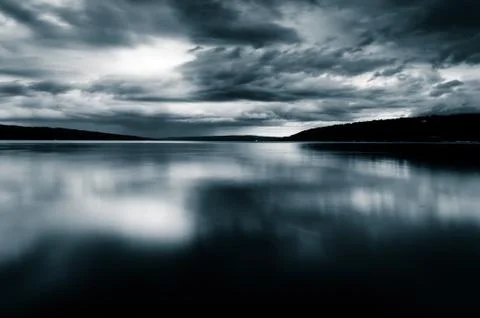 Storm clouds move over lake cayuga in a long exposure, seen from stewart in i Stock Photos