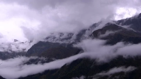 Storm clouds moving among the mountain peaks Stock Footage 59987546