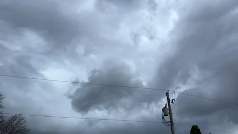 Storm clouds moving over power lines and transformer Stock Footage 305486577
