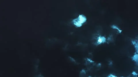 Storm clouds at night over the sea and sparkling lightning in the clouds 스톡 일러스트