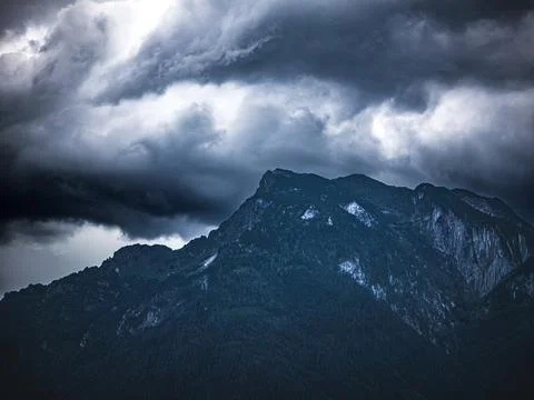 Storm clouds over alpine mountain peak in Salzburg Austria Stock Photos