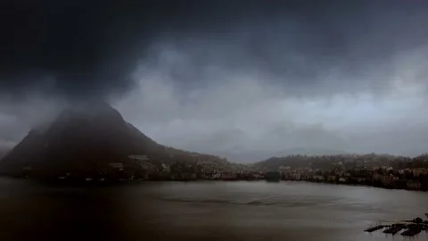 Storm Clouds over City of Lugano and Lake with Mountain View and Sunlight Stock Footage 224334201