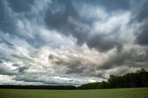 Storm clouds over the field Stock Photos