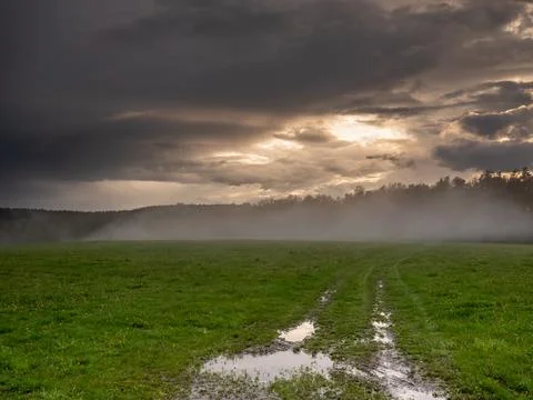 Storm clouds over a field Stock Photos