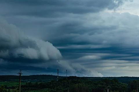 Storm clouds over field, tornadic supercell, extreme weather, dangerous storm Stock Photos