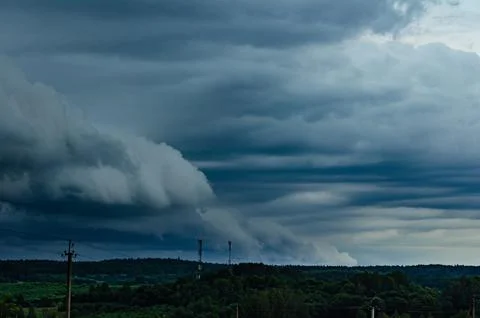 Storm clouds over field, tornadic supercell, extreme weather, dangerous storm Stock Photos