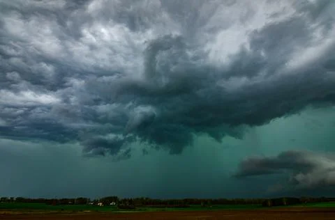 Storm clouds over field, tornadic supercell, extreme weather, dangerous sto.. Stock Photos