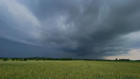 Storm clouds over fields. Summer landscape with stormy sky Stock Footage 243840582