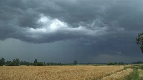 Storm clouds over a flat field Stock Footage 134942273