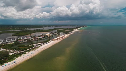 Storm Clouds Over Florida Barrier Beach Resorts and Open Sea, Aerial Fly Along Vídeo Stock 343440816