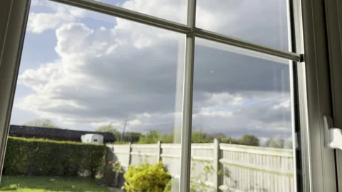 Storm clouds over garden window detail Видео 333636500