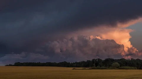 Storm Clouds Over Golden Field at Sunset, Timelapse Stock Footage 343618191