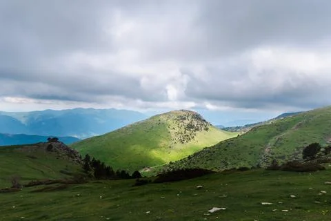 Storm clouds over green mountain ridge in Catalan Pyrenees landscape Fotos Stock