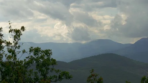 Storm clouds over green mountains Stock Footage 79447177