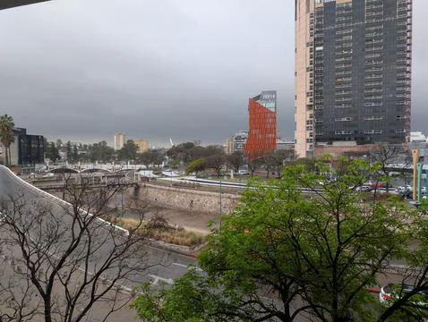 Storm clouds over La Canada canal and city skyline in Cordoba Stock Photos