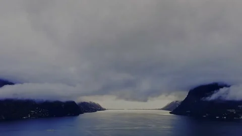 Storm Clouds over Lake Lugano with Mountain Range View and Sunlight Stockbeeldmateriaal 224347076