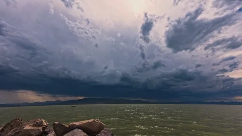 Storm clouds over lake water time lapse Stock Footage 345814317