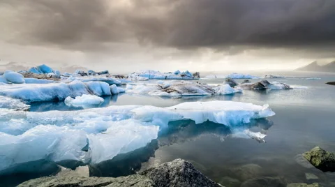 Storm clouds over meling icebergs time-lapse Stock Footage 60975039