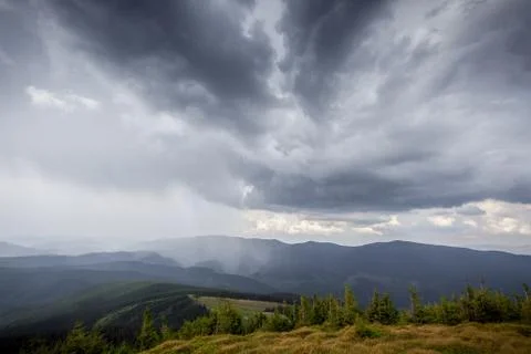 Storm clouds over the mountains Stock Photos