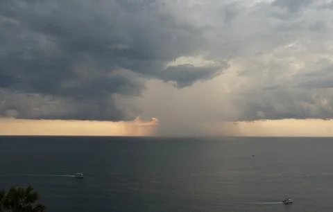 Storm Clouds Over Ocean with Distant Rain Shower Stock Photos
