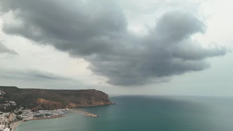 Storm Clouds over Puerto de Javea Marina and Coastal Cliffs, Spain Stock Footage 340470447