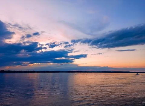 Storm clouds over the river at sunset 2 Stock Photos