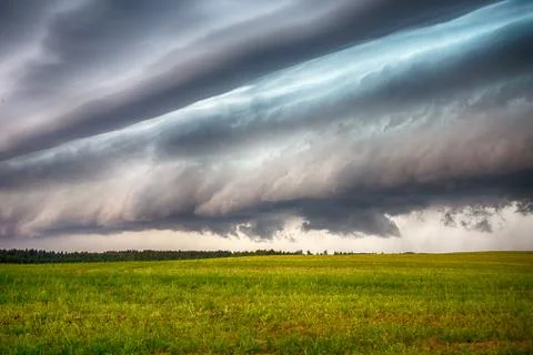 Storm clouds over the sloping field Stock Photos