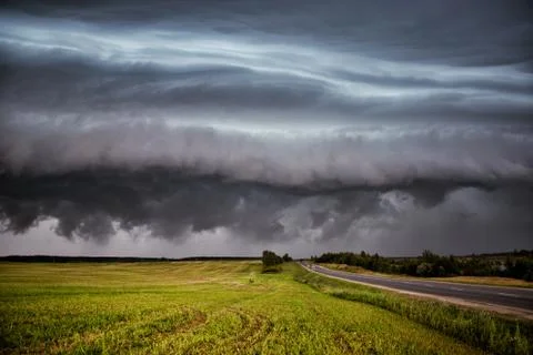Storm clouds over the sloping field Stock Photos