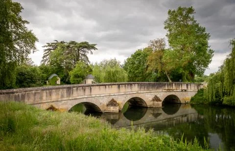 Storm clouds over stone bridge reflections - diagonal line Stock Photos