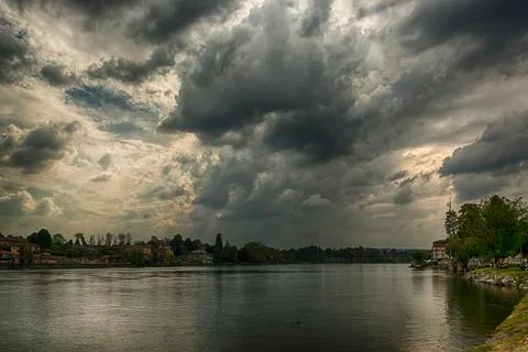Storm clouds over the Ticino river Stock Photos