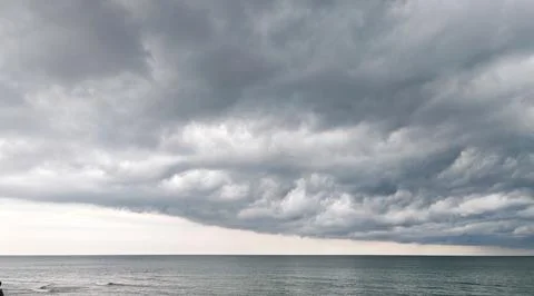 Storm Clouds Over Tranquil Ocean Horizon Fotos de archivo