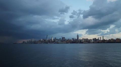 Storm Clouds Passing over Midtown Manhattan with a Rainbow and Lightning Stock Footage 67483789