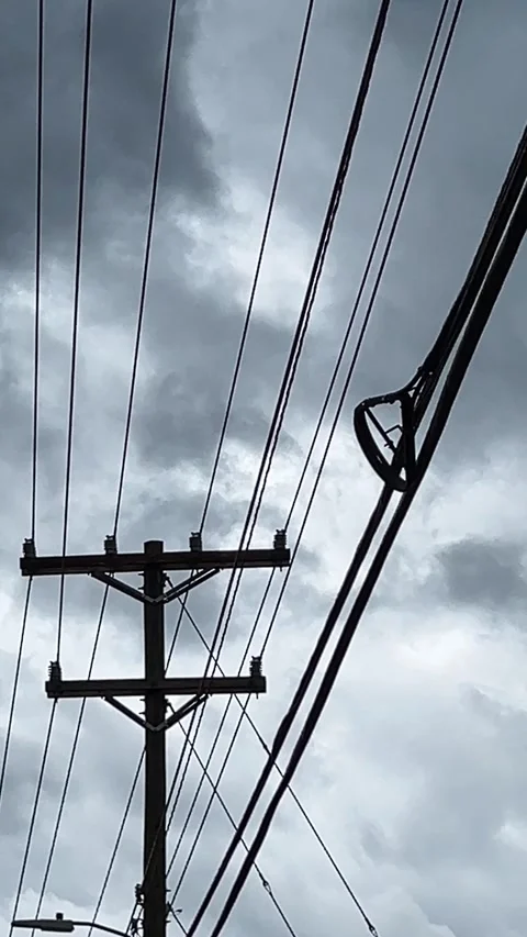 Storm clouds passing quickly through the sky behind high power lines Stock Footage 285991907