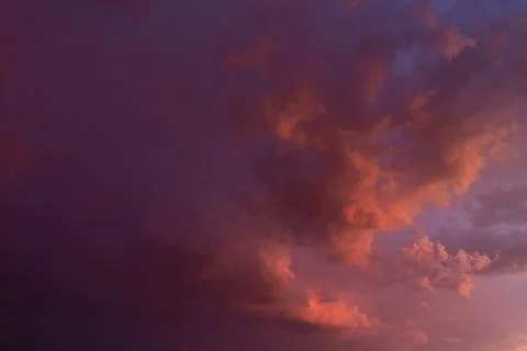 Storm clouds, pink sunset. Stock Photos