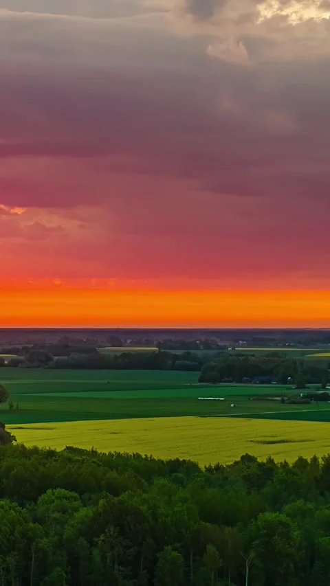 Storm clouds pull back at sunset in drone hyperlapse Video stock 328358945