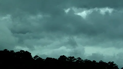 Storm clouds roil from L-R. Tree line in lower third background Stock Footage 39413626