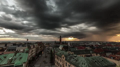 Storm Clouds Rolling Over Helsingborg Town Hall and Rooftops at Sunset Stock Footage 342415252