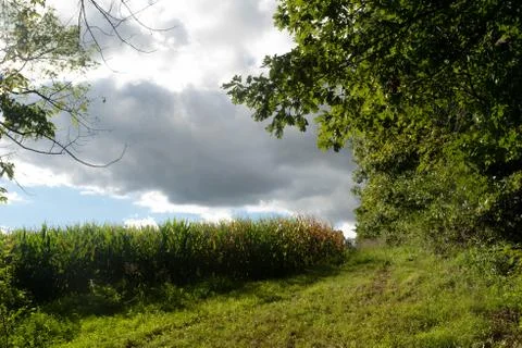 Storm clouds rolling over an idyllic rural landscape Stock Photos