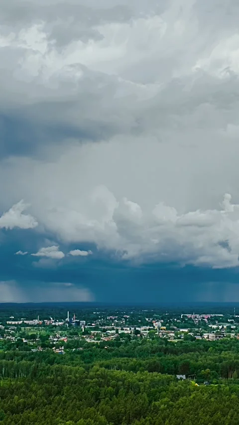 Storm Clouds Rolling Over Town and Forest in Dramatic Daytime Timelapse Stock Footage 339640126