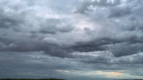 Storm clouds in the sky during sunset.	 Stock Footage 317362787